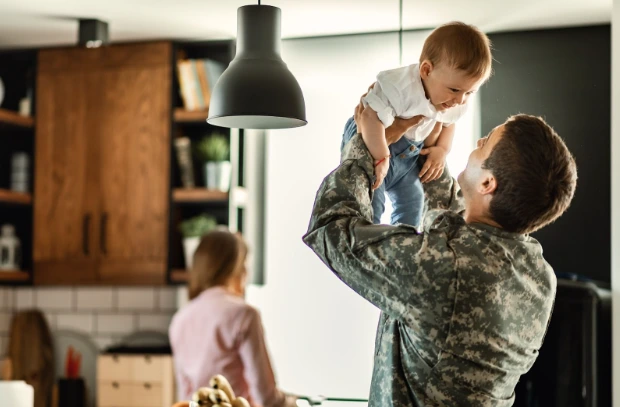 A soldier with his family in a military home.